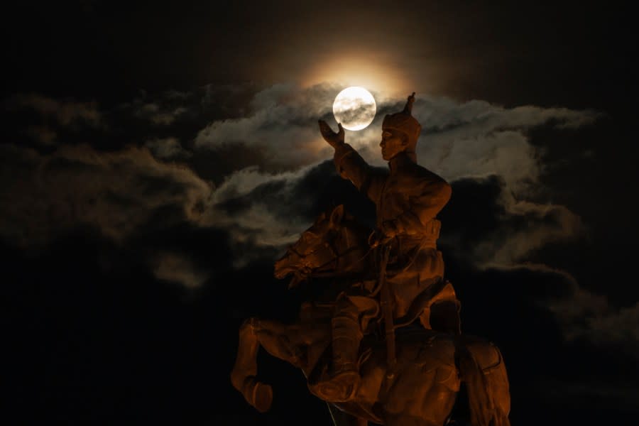The supermoon rises near the equestrian statue of Damdin Sukhbaatar on Sukhbaatar Square in Ulaanbaatar, Mongolia, on Wednesday, Aug. 30, 2023. August 30 sees the month’s second supermoon, when a full moon appears a little bigger and brighter thanks to its slightly closer position to Earth. (AP Photo/Ng Han Guan)