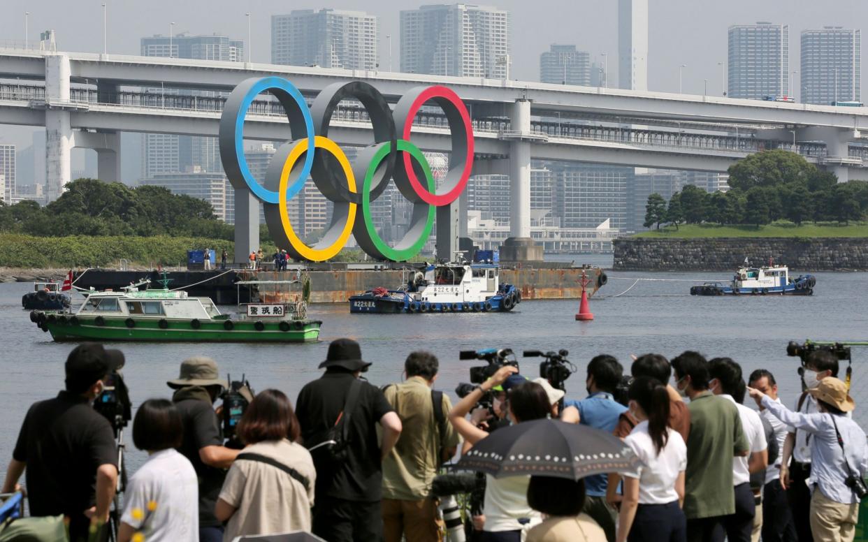 The Olympic Rings at Odaiba Marine Park, the venue of distance swimming and triathlon events of the Olympics, are moved for maintenance in Tokyo - SHUTTERSTOCK