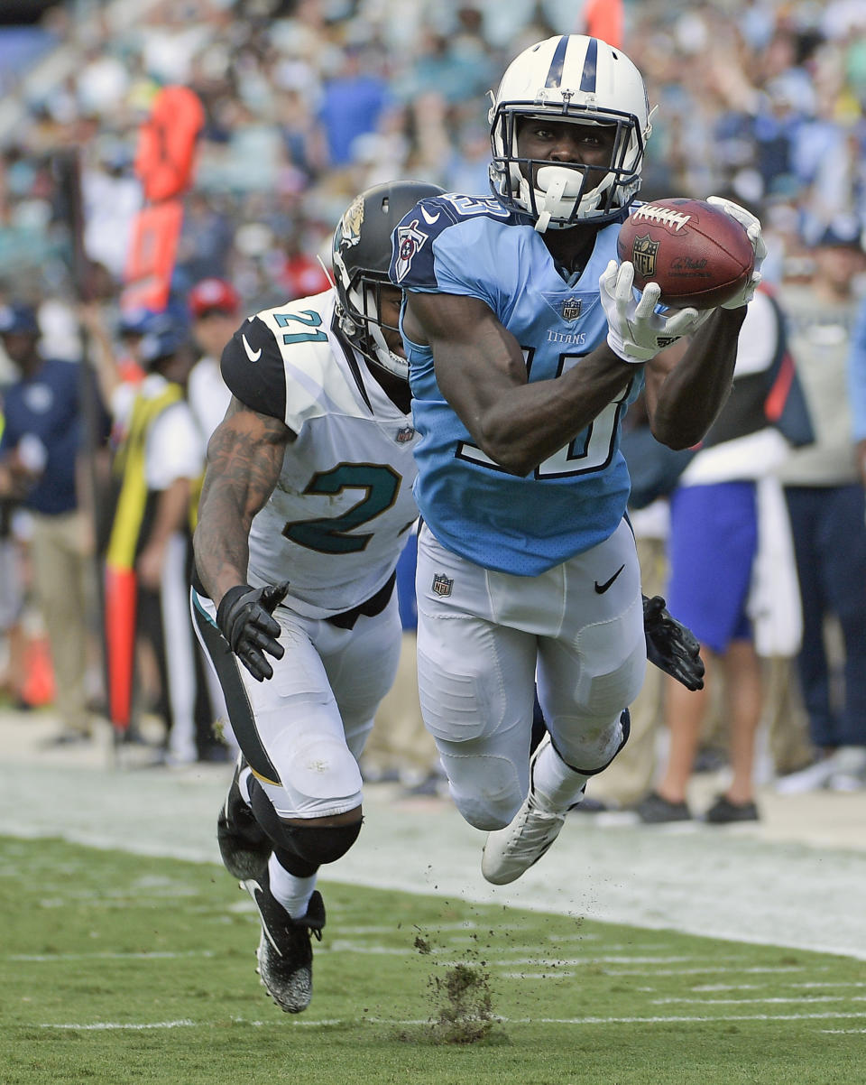 <p>Tennessee Titans wide receiver Taywan Taylor, right, makes a reception in front of Jacksonville Jaguars cornerback A.J. Bouye (21) during the second half of an NFL football game, Sunday, Sept. 17, 2017, in Jacksonville, Fla. (AP Photo/Phelan M. Ebenhack) </p>