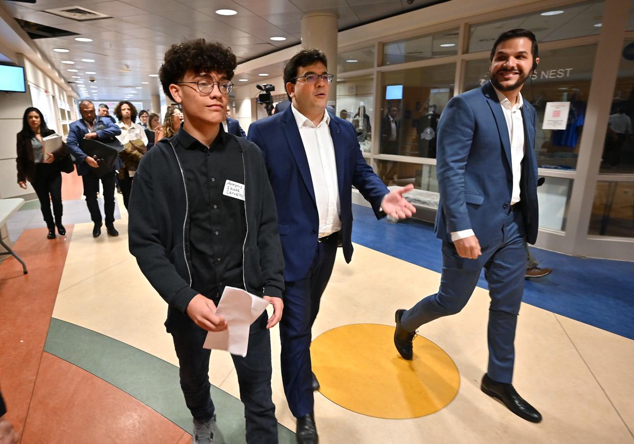 Worcester Technical High School junior Antonio Sousa Carvalho, left, walks with Rafael T. Fonteles, governor of the state of Piaui, Brazil, and F. Washington Bandeira, right, secretary of state of education of Piauí, during Fonteles' visit on Tuesday.