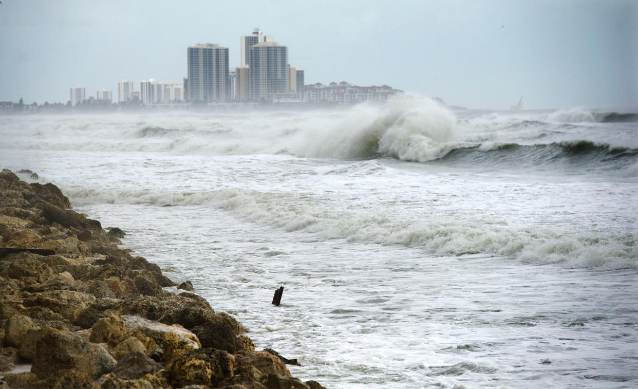 Ocean waves approach the seawall near the Palm Beach Country Club as Hurricane Dorian moves up the coast on Sept. 3, 2019.