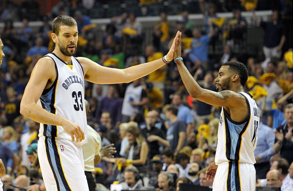 Marc Gasol high fives teammate Mike Conley during Game 1 of the 2015 Western Conference quarterfinals against the Portland Trail Blazers. (Frederick Breedon/Getty Images)