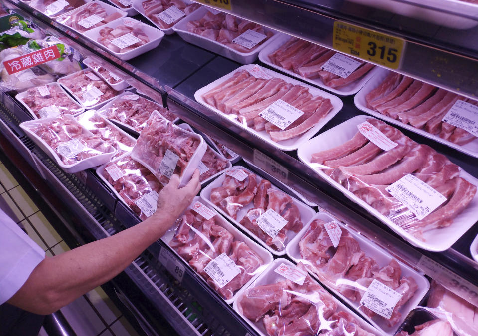 Customers shop for local pork at a supermarket in Taipei, Taiwan, Wednesday, Sept. 23, 2020. Taiwan's government announced recently that Taiwan would ease restrictions on U.S. beef and pork imports, while setting standards for pork containing Ractopamine. (AP Photo/Chiang Ying-ying)