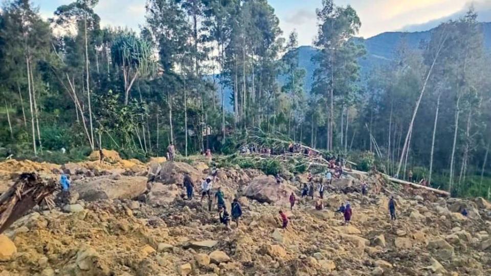 Race to rescue villagers trapped after landslide