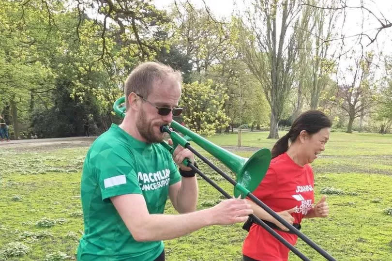 Nathaniel running with his trombone