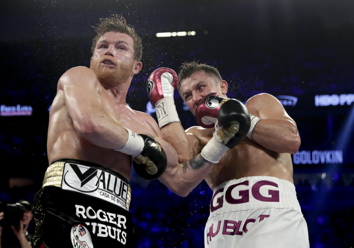 Canelo Alvarez, left, and Gennady Golovkin trade punches in the fourth round during a middleweight title boxing match, Saturday, Sept. 15, 2018, in Las Vegas. (AP Photo/Isaac Brekken)