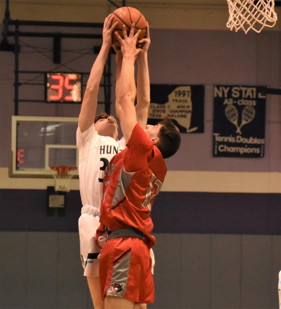 Thomas Jacquays of Central Valley Academy and Colten Christensen of Oppenheim-Ephratah-St. Johnsville (from left) battle for a rebound at Little Falls' Holiday Classic Tournament Friday.