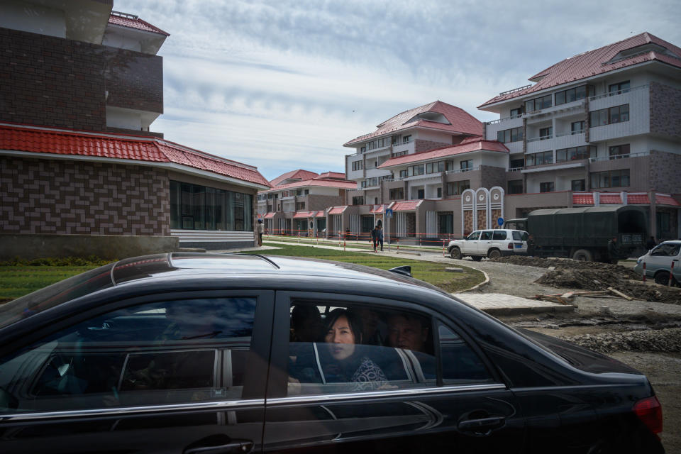 A photo taken on September 10, 2019 shows a car passing along a street in North Korea's northern city of Samjiyon. - The monumental construction project in the far reaches of North Korea ordered by leader Kim Jong Un, involves nothing less than the rebuilding of the entire town of Samjiyon, the seat of a county which includes the supposed birthplace of Kim's father and predecessor Kim Jong Il, and Mount Paektu, the spiritual birthplace of the Korean nation. The plan includes a museum of revolutionary activities, a winter sports training complex, processing plants for blueberries and potatoes -- two of the area's most important crops -- a new railway line to Hyesan, and 10,000 apartments. (Photo by Ed JONES / AFP) / To go with NKorea-politics-economy-construction-Samjiyon, FOCUS by Sebastien Berger        (Photo credit should read ED JONES/AFP via Getty Images)