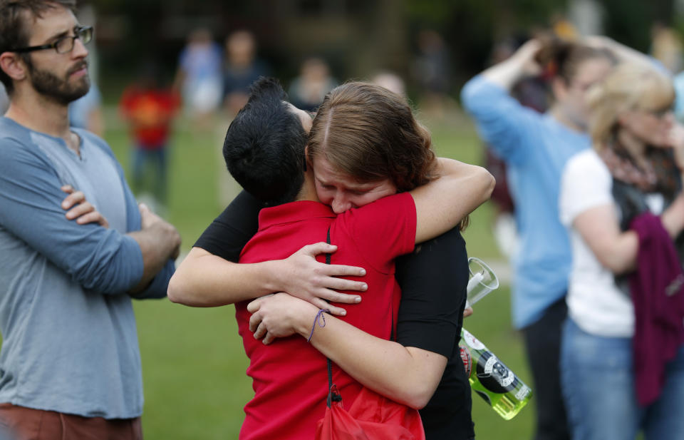 Friends of slain Iowa State University student Celia Barquin Arozamena react during a vigil, Wednesday, Sept. 19, 2018, in Ames, Iowa. Barquin, who was the 2018 Big 12 women's golf champion and Iowa State Female Athlete of the Year, was found Monday morning in a pond at a golf course near the Iowa State campus. (AP Photo/Charlie Neibergall)