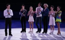 Patrick Chan of Canada, left, speaks on behalf of the skaters during the figure skating exhibition gala at the Iceberg Skating Palace during the 2014 Winter Olympics, Saturday, Feb. 22, 2014, in Sochi, Russia. In back, from right to left, Adelina Sotnikova of Russia, Meryl Davis and Charlie White of the United States, Tatiana Volosozhar and Maxim Trankov of Russia, and Yuzuru Hanyu of Japan. (AP Photo/Ivan Sekretarev)