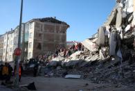 Search and rescue teams work on a collapsed building after an earthquake in Elazig