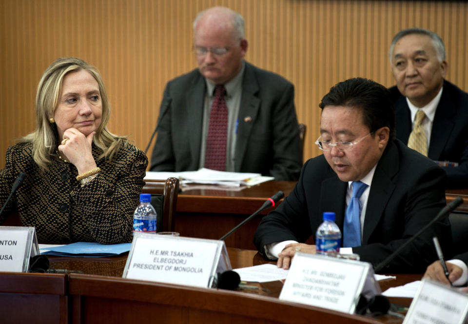 U.S. Secretary of State Hillary Rodham Clinton, left, listens as Mongolian President Elbegdori Tsakhia, right, delivers the opening remarks to the Community of Democracies Governing Council, at the Ministry of Foreign Affairs Monday, July 9, 2012 in Ulan Bator, Mongolia. (AP Photo/Brendan Smialowski, Pool)