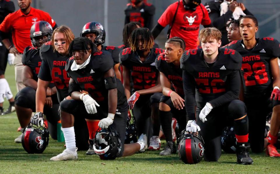 Members of the Rolesville football team watch as Vance accepts its trophy after Vance High School’s 35-14 victory over Rolesville High School in the NCHSAA 4AA state championship at Carter-Finley Stadium in Raleigh, N.C., Saturday, May 8, 2021.