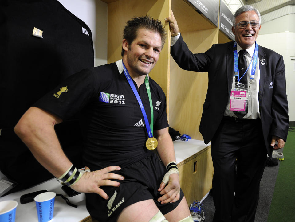 FILE - In this Oct. 23, 2011, file photo, New Zealand All Blacks captain Richie McCaw, left, poses with chairman of the New Zealand Rugby Union Bryan Williams in the dressing room after the Rugby World Cup final at Eden Park, Auckland, New Zealand. New Zealand Rugby has granted conditional approval, Wednesday, April 14, 2021, for two Pacific Islands teams to join an Australia-New Zealand Super Rugby tournament beginning next year. (AP Photo/Ross Land, FIle)