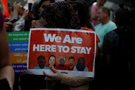 A demonstrator holds a sign during a rally against the rescindment of DACA (Deferred Action for Childhood Arrivals) program outside the San Francisco Federal Building in San Francisco, California, U.S., September 5, 2017. REUTERS/Stephen Lam