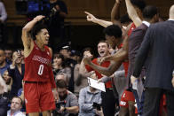 Louisville guard Lamarr Kimble (0) celebrates with the bench at the end of the team's NCAA college basketball game against Duke in Durham, N.C., Saturday, Jan. 18, 2020. Louisville won 79-73. (AP Photo/Gerry Broome)