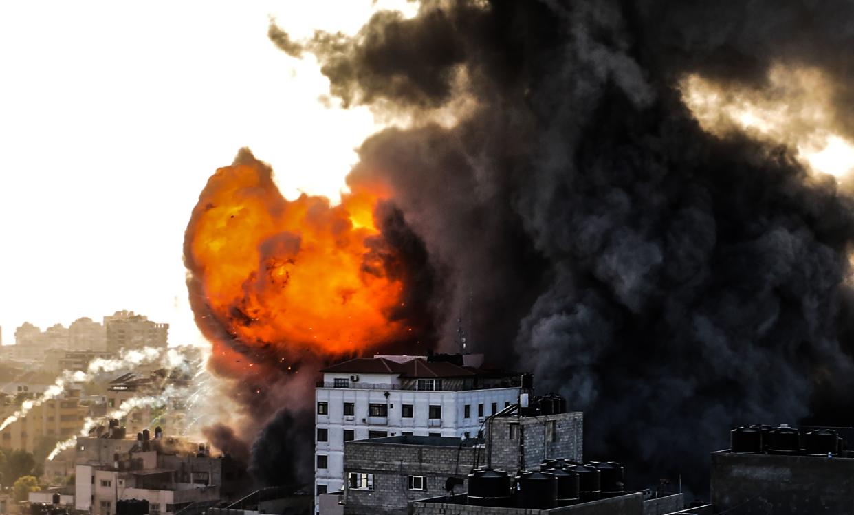 Smoke rises from 14-story building as Israeli fighter jets continue to pound a Palestinian building called "Ash-Shuruq" at Omar Al-Mukhtar neighbourhood in the Gaza Strip, on May 12. 