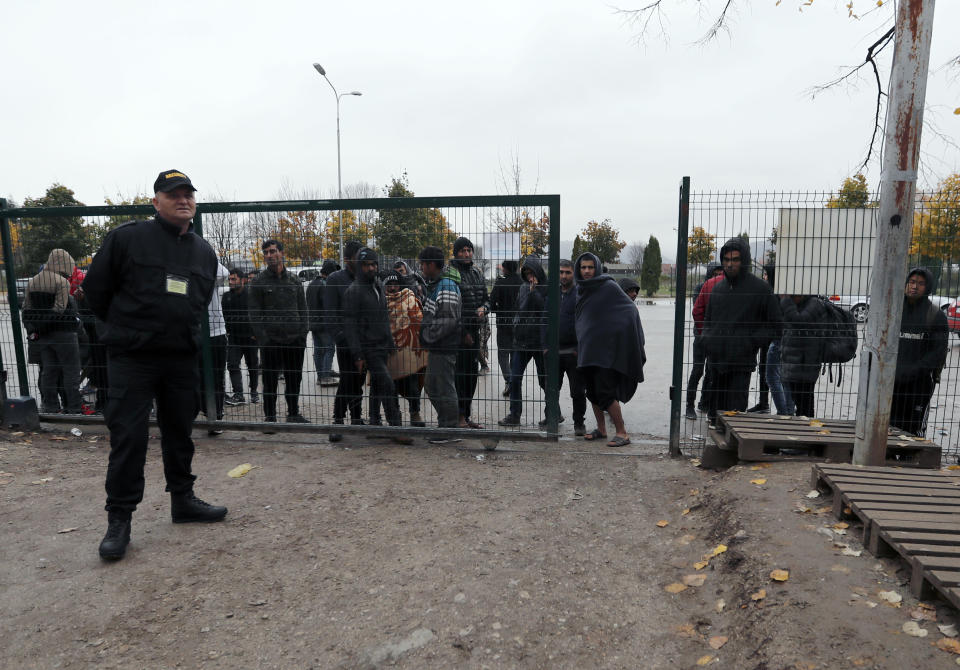 Migrants wait to enter in the Bira refugee camp in Bihac, northwestern Bosnia, Thursday, Nov. 14, 2019. The European Union's top migration official is warning Bosnian authorities of a likely humanitarian crisis this winter due to appalling conditions in overcrowded migrant camps in the country. (AP Photo/Darko Vojinovic)