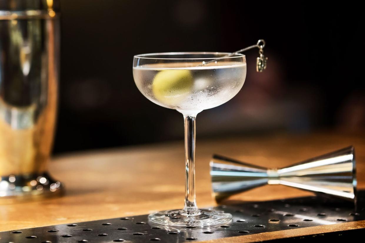A gin martini resting on a bar