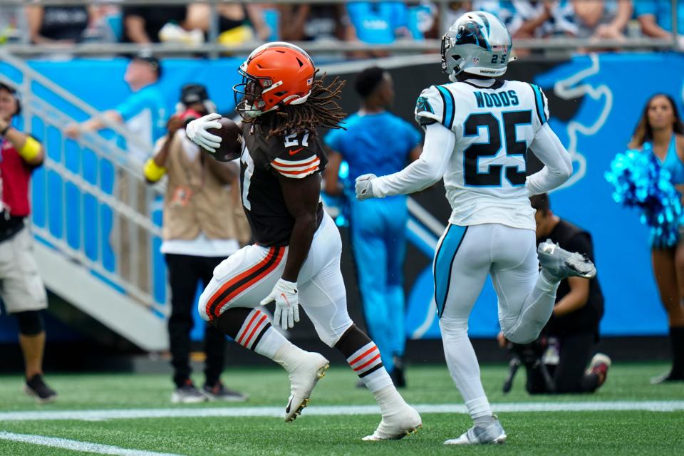 Cleveland Browns running back Kareem Hunt scores past Carolina Panthers safety Xavier Woods during the first half of an NFL football game on Sunday, Sept. 11, 2022, in Charlotte, N.C. (AP Photo/Rusty Jones)