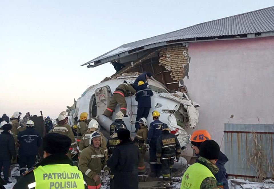 In this photo provided by the Emergency Situations Ministry of the Republic of Kazakhstan, police and rescuers work on the side of a plane crashed near Almaty International Airport, outside Almaty, Kazakhstan, Friday, Dec. 27, 2019. Almaty International Airport said a Bek Air plane crashed Friday in Kazakhstan shortly after takeoff causing numerous deaths. (Emergency Situations Ministry of the Republic of Kazakhstan via AP)