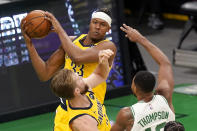 Indiana Pacers center Myles Turner (33) grabs a rebound next to Boston Celtics forward Tristan Thompson during the first quarter of an NBA basketball game Friday, Feb. 26, 2021, in Boston. (AP Photo/Elise Amendola)