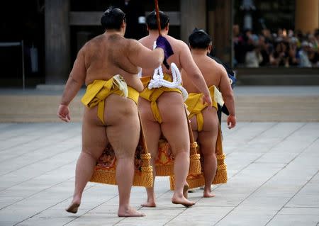 Mongolian-born grand sumo champion Yokozuna Hakuho (C) leaves after performing the New Year's ring-entering rite at the annual celebration for the New Year at Meiji Shrine in Tokyo, Japan January 6, 2017. REUTERS/Issei Kato