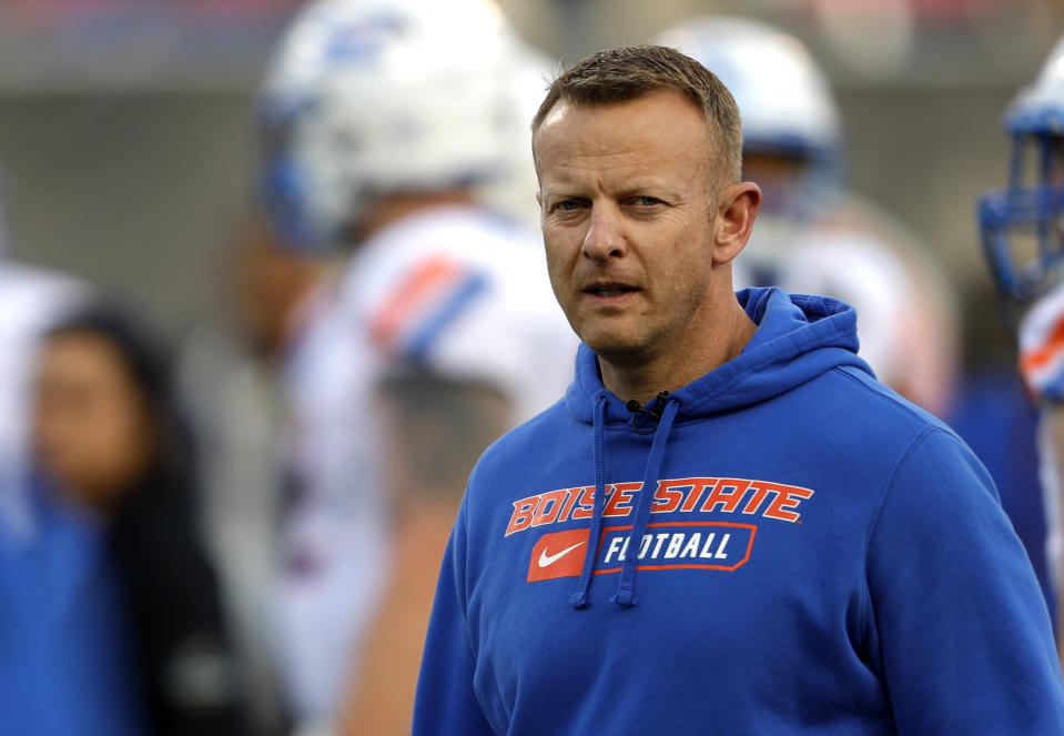 FILE - In this Saturday, Dec. 21, 2019 file photo, Boise State coach Bryan Harsin watches his players warm up for the Las Vegas Bowl NCAA college football game against Washington at Sam Boyd Stadium in Las Vegas. No. 25 San Jose State will face perennial conference powerhouse Boise State in the Mountain West championship on Saturday, Dec. 19, 2020 in Las Vegas. The game is usually played on the higher seed’s home field but this year it will be held at Sam Boyd Stadium. (AP Photo/Steve Marcus, File)