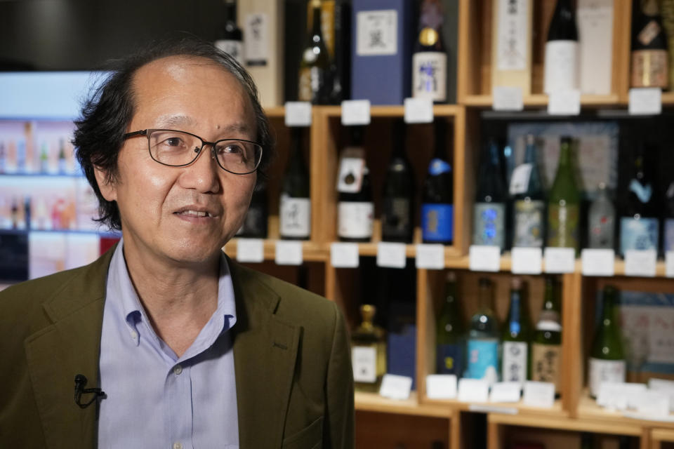 Shuso Imada, general manager for the Japan Sake and Shochu Makers Association Information Center, speaks in an interview with The Associated Press during a sake and shochu tasting event at the information center in Tokyo, Wednesday, June 22, 2022. Imada said he has been feeling pretty lonely and is itching to tell foreign visitors about how to match the traditional Japanese rice wine with all kinds of non-Japanese food, even cheese and beef. (AP Photo/Hiro Komae)