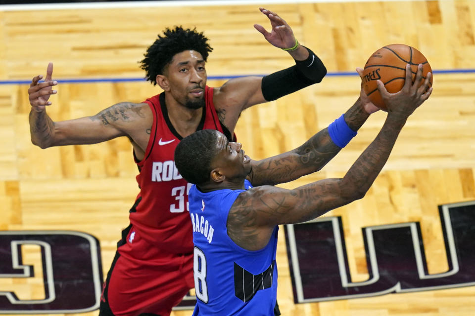 Orlando Magic guard Dwayne Bacon (8) goes past Houston Rockets center Christian Wood for a shot during the second half of an NBA basketball game, Sunday, April 18, 2021, in Orlando, Fla. (AP Photo/John Raoux)