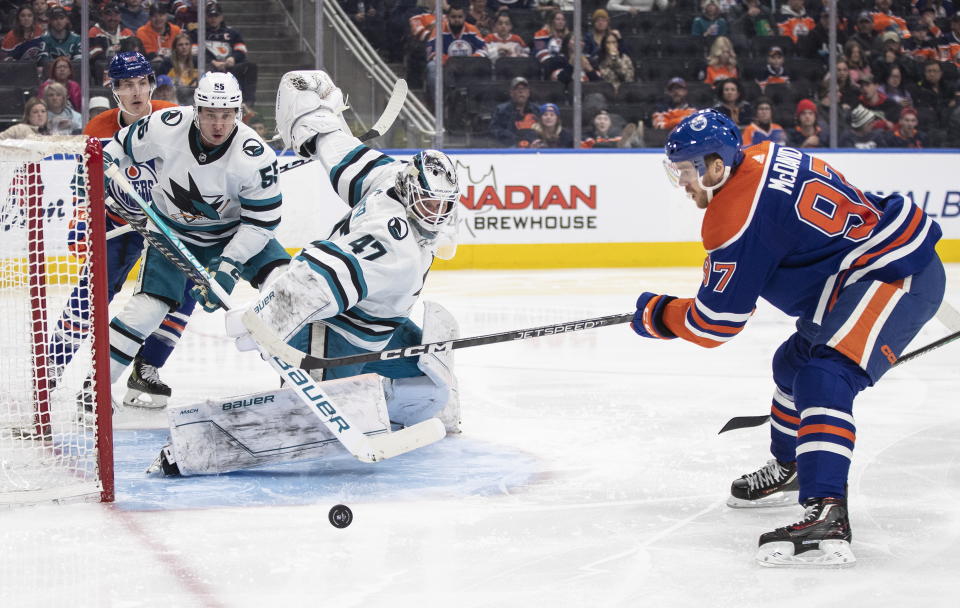 San Jose Sharks goalie James Reimer (47) makes a save against Edmonton Oilers' Connor McDavid (97) during second-period NHL hockey game action in Edmonton, Alberta, Monday, March 20, 2023. (Jason Franson/The Canadian Press via AP)