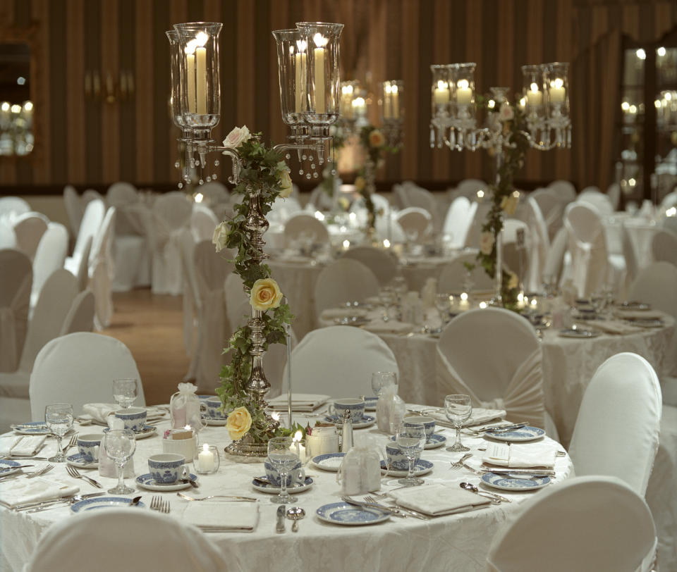 Elegant table setting for a romantic dinner with floral centerpieces and candlelight