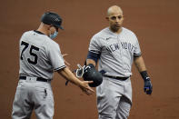 New York Yankees' Rougned Odor, right, hands his helmet to first base coach Reggie Willits after popping out against the Tampa Bay Rays during the second inning of a baseball game Sunday, April 11, 2021, in St. Petersburg, Fla. (AP Photo/Chris O'Meara)