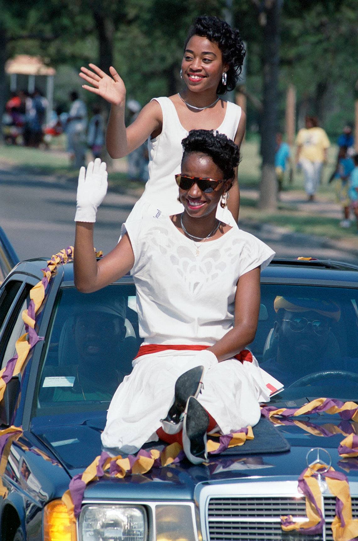 Carla Geiger, front, and Sheila Hall wave to the crowd watching a 1988 Juneteenth parade along Rosedale Street in Fort Worth.