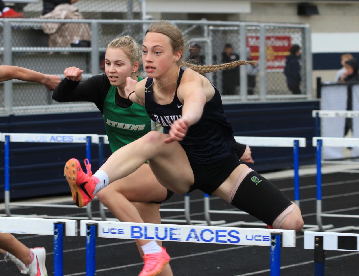 Granville's Ayla Cook runs the 100 hurdles at the Granville Invitational on Friday.