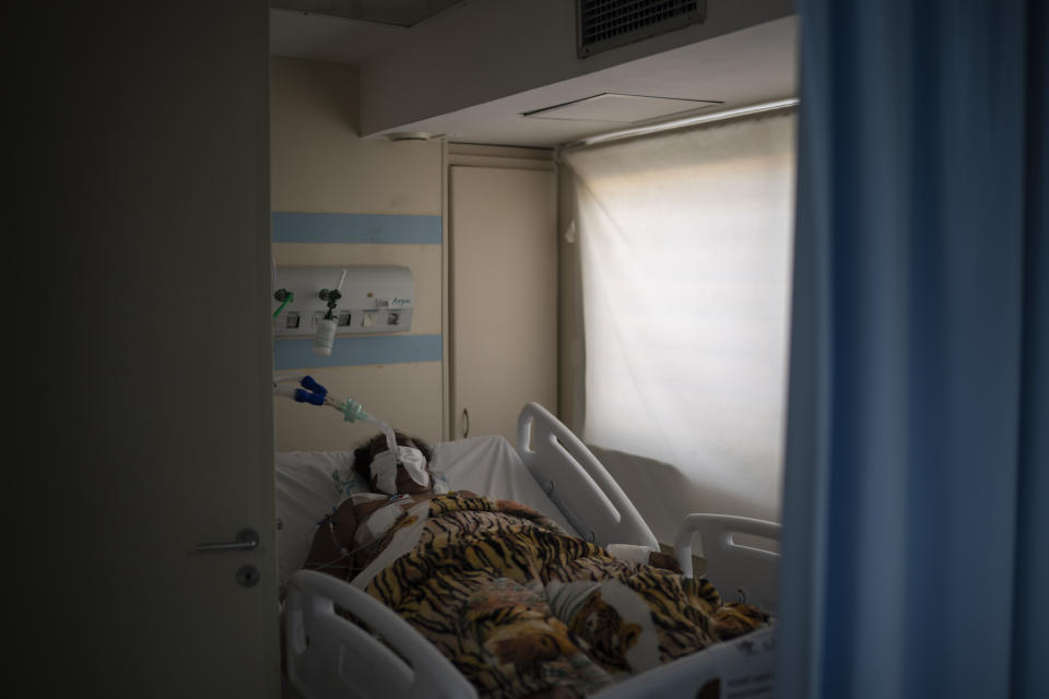 An intubated COVID-19 patient is treated in the ICU of the Sao Jose municipal hospital, in Duque de Caxias, Brazil, Wednesday, March 24, 2021. (AP Photo/Felipe Dana)