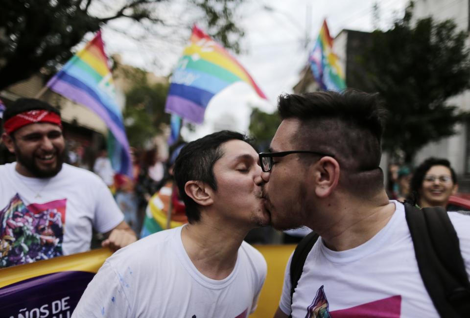 Two men kiss during the Gay Pride parade in Asuncion, Paraguay, Saturday, June 29, 2019. (AP Photo/Jorge Saenz)