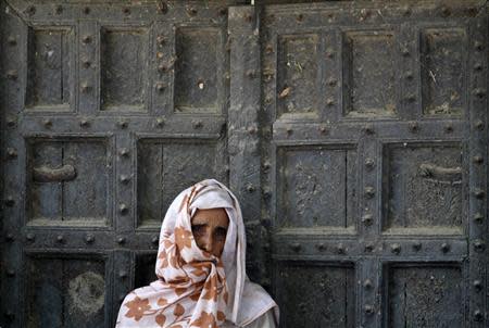 A villager listens to an address given by Rahul Gandhi, a lawmaker and the son of India's ruling Congress party chief Sonia Gandhi, to a gathering after Saturday's clash between farmers and police at Parsaul village in Gautam Buddha Nagar district of the northern Indian state of Uttar Pradesh in this May 11, 2011 file photo. REUTERS/Parivartan Sharma/Files