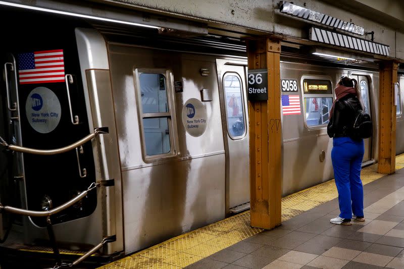 A morning commuter waits for the subway, during the outbreak of the coronavirus disease (COVID-19) in Brooklyn, New York