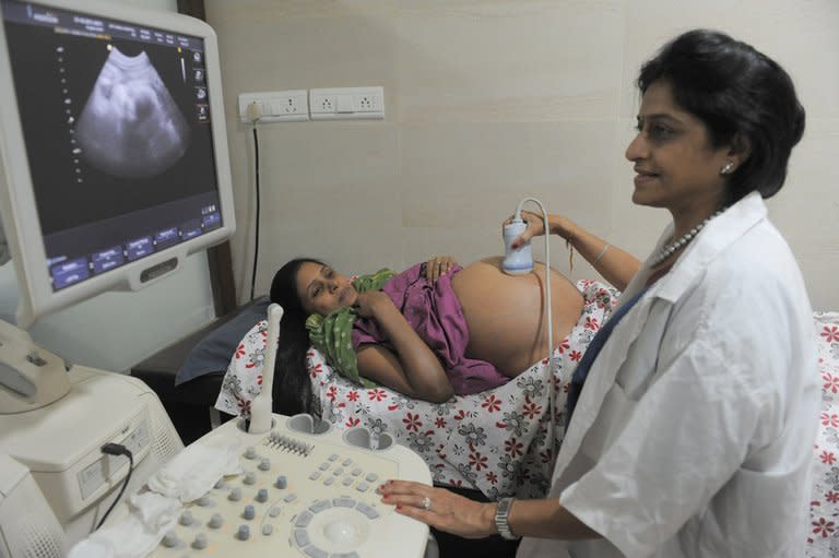 Dr. Nayna Patel (right), a pioneer of reproductive surrogacy in India, conducts an ultrasound on 30-year-old surrogate mother Rinku Macwan, bearing twin babies, at Kaival Hospital in Anand, some 90 kms from Ahmedabad, on October 31, 2011. The Confederation of Indian Industry, a leading business association, estimates the industry now generates more than $2 billion in revenues annually