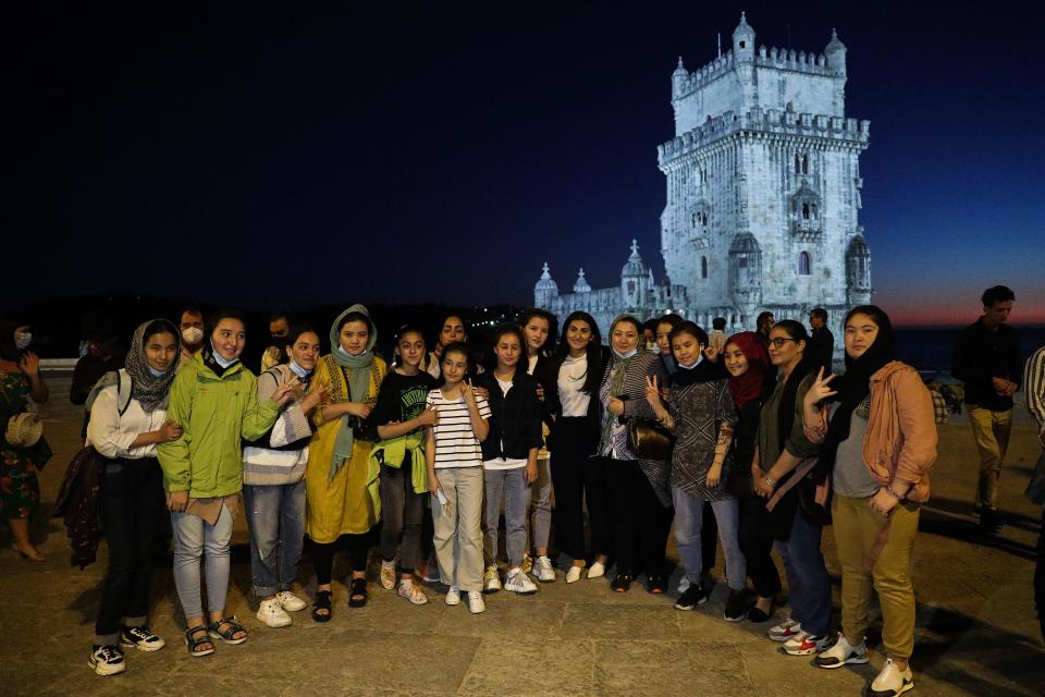 The captain of Afghanistan national women football team, Farkhunda Muhtaj (C), poses with teammates after welcoming them in Portugal at Belem Tower in Lisbon on September 29, 2021. (Photo by CARLOS COSTA / AFP) (Photo by CARLOS COSTA/AFP via Getty Images)