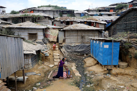 A Rohingya refugee girl collects water from a tube-well at the Balikhali camp in Cox's Bazar, Bangladesh, November 14, 2018. REUTERS/Mohammad Ponir Hossain