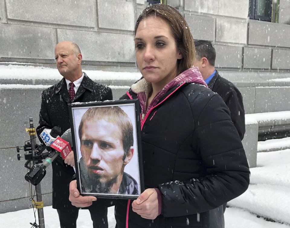 FILE - Trista Reynolds holds a picture of Justin DiPietro, estranged father of her missing daughter Ayla Reynolds, during a news conference, Dec. 17, 2018, in Portland, Maine. (AP Photo/Patrick Whittle, File)