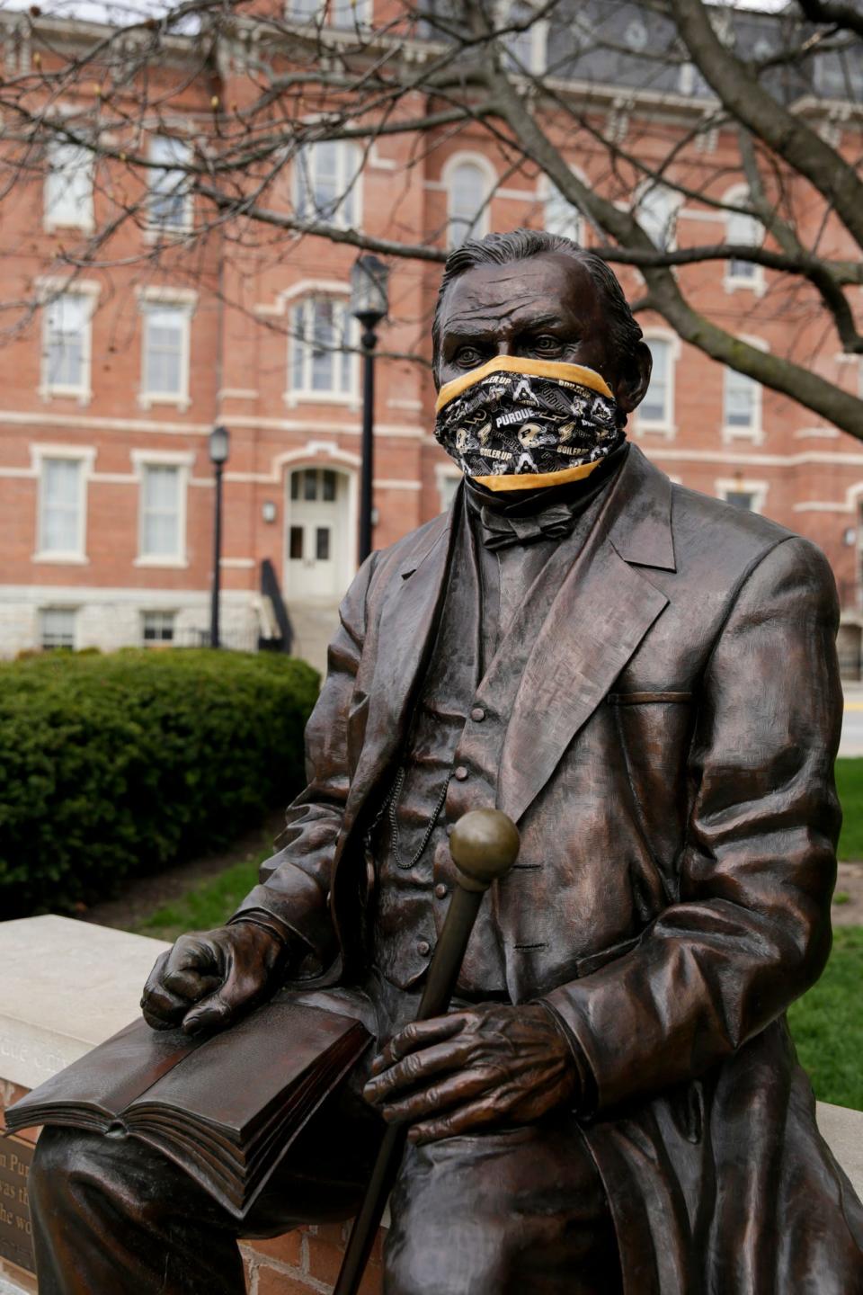 A statue of John Purdue, the founder of Purdue University, was wearing a mask on April 7 in West Lafayette, Indiana.