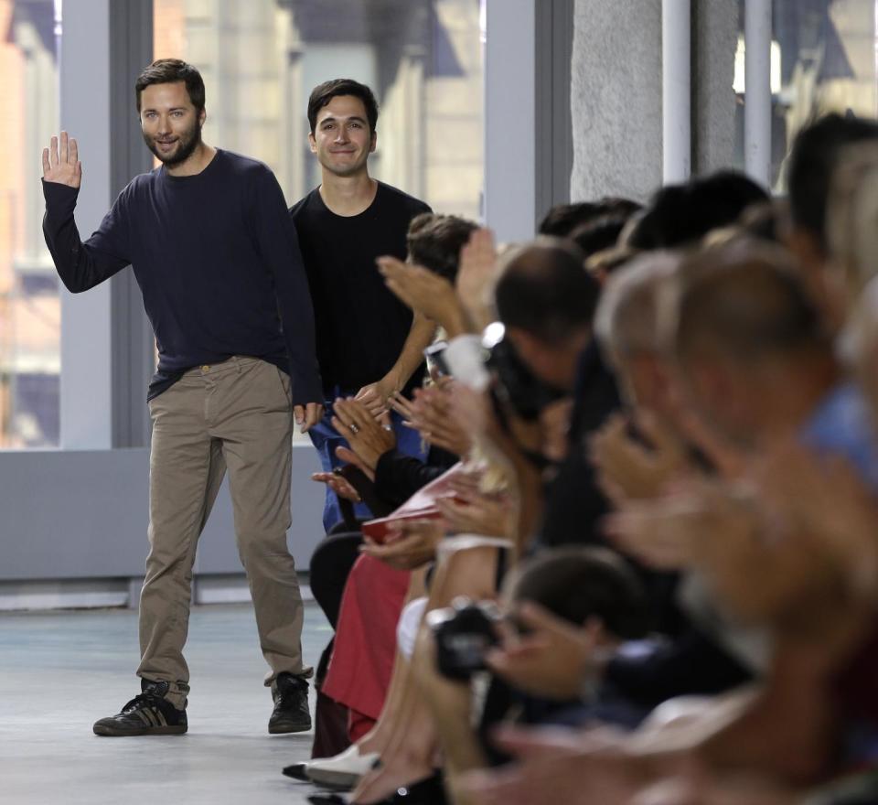 Proenza Schouler designers Jack McCollough, left, and Lazaro Hernandez greet the crowd after showing their Spring 2014 collection during Fashion Week in New York, Wednesday, Sept. 11, 2013. (AP Photo/Seth Wenig)