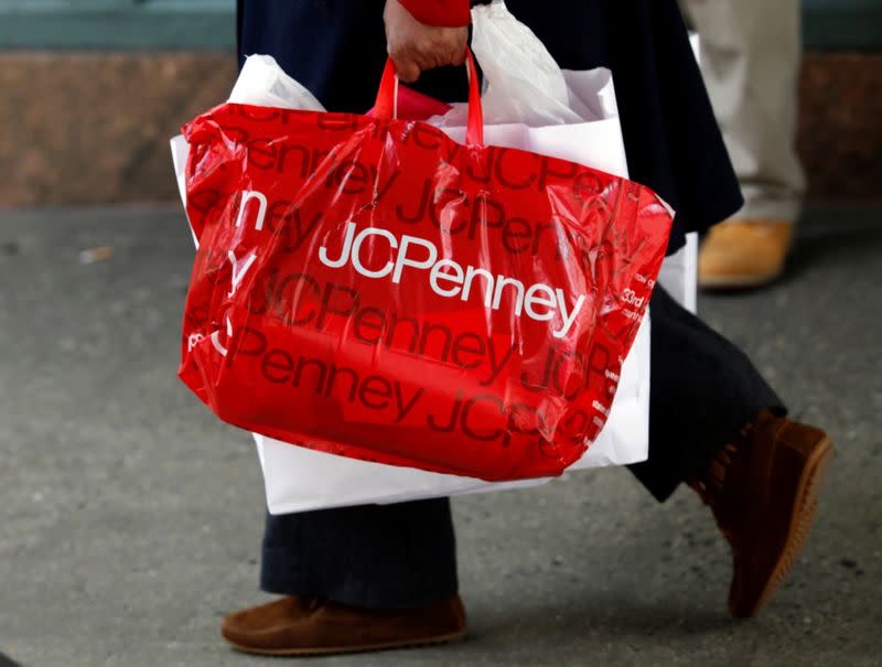 FILE PHOTO: A pedestrian walks with a shopping bag from a J.C. Penney department store in New York