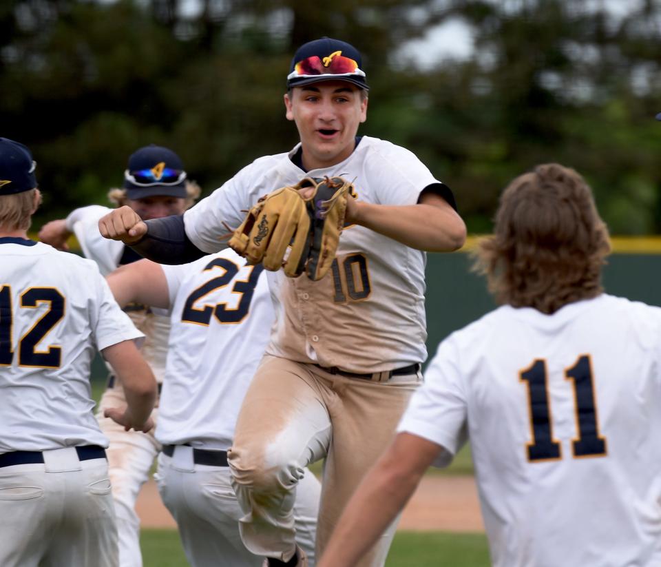 Shade Daniels of Airport celebrates with his teammates after they beat New Boston Huron in the D2 District Semifinal game 7-1 Saturday, June 4, 2022.