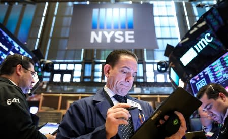 Traders work on the floor at the NYSE in New York