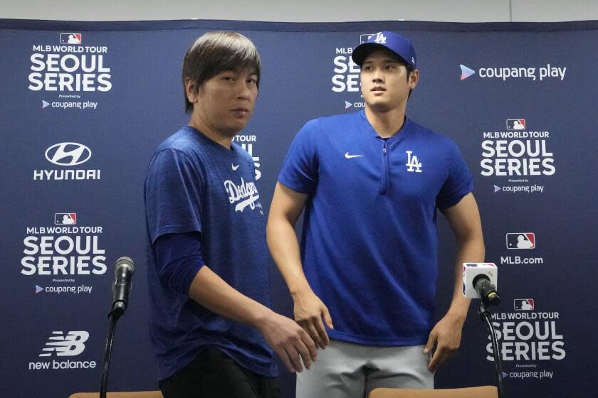 Los Angeles Dodgers' Shohei Ohtani, right, and his interpreter, Ippei Mizuhara, leave after at a news conference ahead of a baseball workout at Gocheok Sky Dome in Seoul, South Korea, Saturday, March 16, 2024. Ohtani's interpreter and close friend has been fired by the Dodgers following allegations of illegal gambling and theft from the Japanese baseball star. (AP Photo/Lee Jin-man)