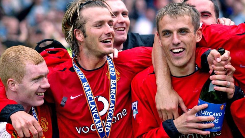 David Beckham (middle) and Phil Neville (right) celebrate Manchester United’s Premiership trophy in 2003. They will be reunited at Inter Miami -- Beckham is co-owner and hiring Neville to become team’s new coach for 2021.